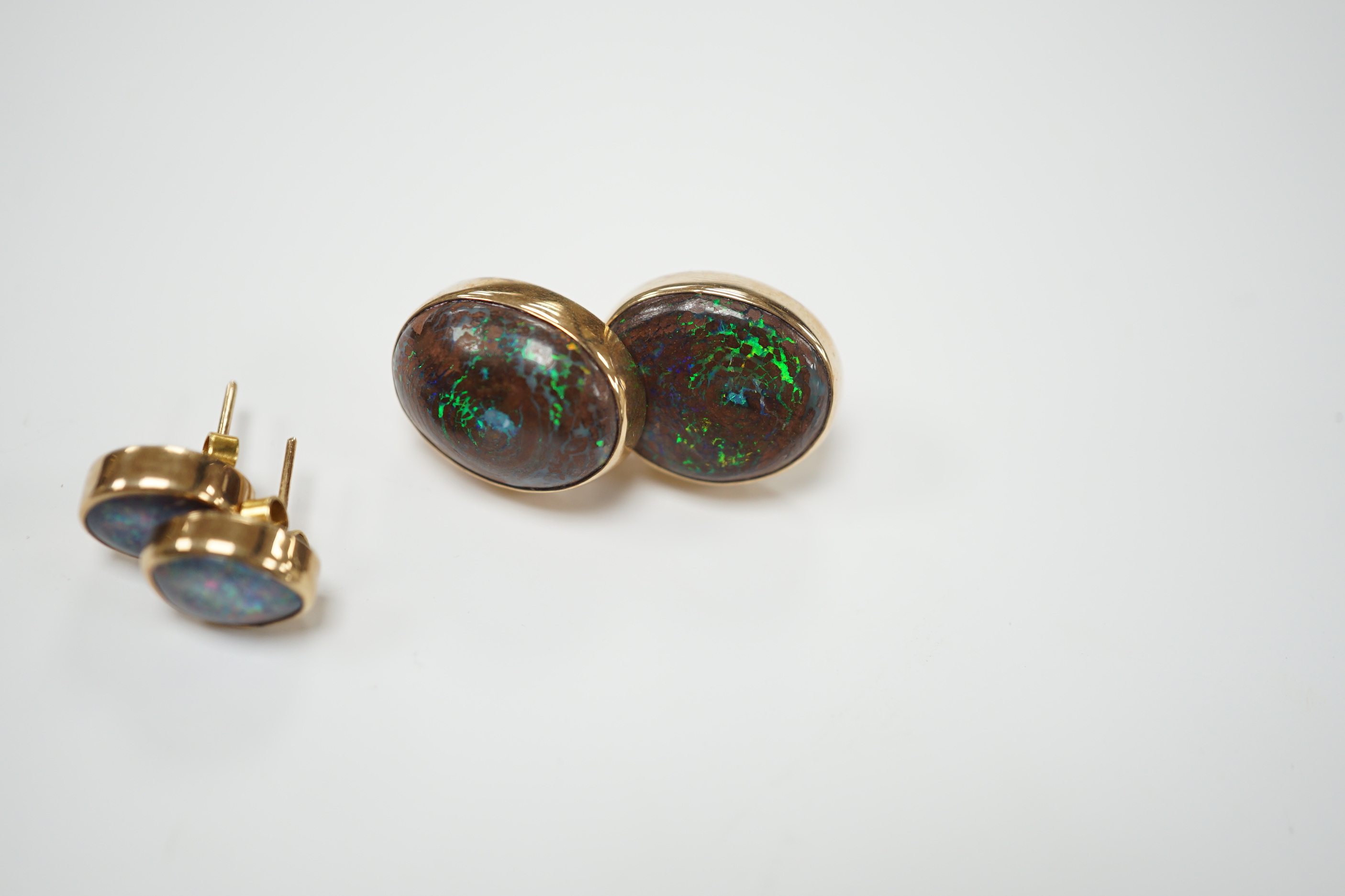 Two pairs of yellow metal and oval opal doublet set earrings, the smaller stamped 9ct, largest 17mm, gross weight 11 grams.